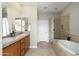 Bright bathroom with double sinks, a glass enclosed shower and a soaking tub at 20750 N 87Th St # 2074, Scottsdale, AZ 85255