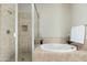 Bright bathroom featuring a tiled soaking tub and glass enclosed shower at 20750 N 87Th St # 2074, Scottsdale, AZ 85255