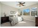 Bright bedroom features a ceiling fan, carpeted floors, and large windows with stunning mountain views at 20750 N 87Th St # 2074, Scottsdale, AZ 85255