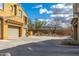 Stunning exterior view with desert landscape, yellow stucco and ample parking at 20750 N 87Th St # 2074, Scottsdale, AZ 85255