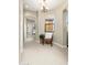 Well-lit hallway with neutral decor, a chair, leading to other rooms in the home at 20750 N 87Th St # 2074, Scottsdale, AZ 85255