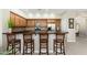 Open kitchen boasts a breakfast bar, wooden cabinetry, stainless appliances, and stylish countertops at 20750 N 87Th St # 2074, Scottsdale, AZ 85255