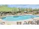 Resort-style community pool with ample lounge chairs, cactus landscaping, and covered seating areas at 20750 N 87Th St # 2074, Scottsdale, AZ 85255