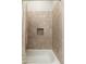Close-up of the shower with tiled walls, a built-in niche, and curtain at 20750 N 87Th St # 2074, Scottsdale, AZ 85255