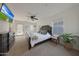 Serene bedroom featuring a ceiling fan, neutral carpet, and a private door leading to the outdoors at 20911 W White Rock Rd, Buckeye, AZ 85396