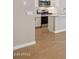 Partial view of kitchen area featuring stainless steel appliances and wood-style flooring at 21130 N 58Th St, Phoenix, AZ 85054
