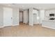 Open-concept living area showcasing hardwood floors, neutral paint, and seamless flow into the modern kitchen at 21130 N 58Th St, Phoenix, AZ 85054