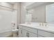 Bright bathroom features a shower-tub combo and white vanity with double sinks at 21240 N 58Th St, Phoenix, AZ 85054