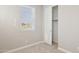 Standard bedroom with neutral carpet, walls, and trim with a window and closet to the right at 21240 N 58Th St, Phoenix, AZ 85054