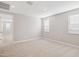 Neutral carpet, walls, and trim with natural light from 3 windows create a cozy and inviting room at 21240 N 58Th St, Phoenix, AZ 85054