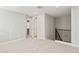 A cozy loft with neutral carpet and walls, next to a railing and open hallway at 21240 N 58Th St, Phoenix, AZ 85054