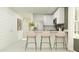Bright kitchen featuring a breakfast bar with seating, stainless steel appliances, and modern fixtures at 25069 N 174Th Ln, Surprise, AZ 85387