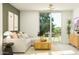 Open-concept living room with a sofa, view to the patio, and modern lighting at 25069 N 174Th Ln, Surprise, AZ 85387