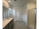 Bathroom featuring double sinks, tiled flooring, a shower, and a large mirror at 25170 W Wayland Dr, Buckeye, AZ 85326