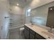 Bright bathroom featuring a double vanity, a soaking tub, and a large mirror, creating a modern, spacious feel at 25170 W Wayland Dr, Buckeye, AZ 85326