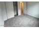Neutral bedroom with neutral carpet, two closets, and doorway to another room at 25170 W Wayland Dr, Buckeye, AZ 85326
