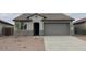 Charming single-story home featuring a low-maintenance front yard, two-car garage, and neutral color scheme at 25170 W Wayland Dr, Buckeye, AZ 85326