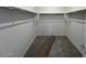 Walk-in closet featuring shelving and a carpeted floor at 25170 W Wayland Dr, Buckeye, AZ 85326