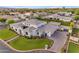 High-angle aerial view revealing a vast estate with manicured lawns and a circular driveway leading to the grand entrance at 2742 W Monterey Pl, Chandler, AZ 85224