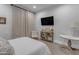 Bedroom featuring neutral tones, a cozy chair, and a decorative console table at 2742 W Monterey Pl, Chandler, AZ 85224