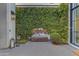 Picturesque courtyard featuring a lush green wall, modern water feature and accent lighting at 2742 W Monterey Pl, Chandler, AZ 85224