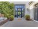 Charming courtyard entrance with ivy wall, water feature, and modern glass door at 2742 W Monterey Pl, Chandler, AZ 85224