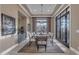 Formal dining room with a modern chandelier, designer rug, wainscoting, and access to outdoor space at 2742 W Monterey Pl, Chandler, AZ 85224