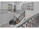 Bright hallway featuring staircase and black and silver metal railings leading to the upper level at 2742 W Monterey Pl, Chandler, AZ 85224