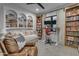 Cozy living room with custom bookshelves, a daybed, and a modern work space at 2742 W Monterey Pl, Chandler, AZ 85224