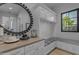 Well-lit mud room boasts large mirror, counter space, storage cabinets, and a bench seat beneath a window at 2742 W Monterey Pl, Chandler, AZ 85224