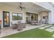 Outdoor patio space with ceiling fan, dining sets and manicured turf at 2742 W Monterey Pl, Chandler, AZ 85224