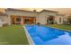 Backyard featuring a gorgeous pool, lush landscaping, and outdoor seating, perfect for relaxation and entertaining at 2742 W Monterey Pl, Chandler, AZ 85224