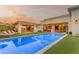 Inviting backyard with a pristine pool, outdoor kitchen, and lounge area at 2742 W Monterey Pl, Chandler, AZ 85224