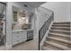 Wet bar with small refrigerator and snack station leading to the carpeted staircase with black metal railing at 2742 W Monterey Pl, Chandler, AZ 85224