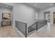 Hallway with staircase featuring modern railings and tiled floors, leading to other areas of the home at 2742 W Monterey Pl, Chandler, AZ 85224