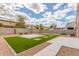 A shot of the large backyard with artificial turf and easy to maintain desert landscaping at 30303 W Whitton Ave, Buckeye, AZ 85396