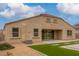 Back of the home featuring low maintenance landscaping, patio and an air conditioning unit at 30303 W Whitton Ave, Buckeye, AZ 85396