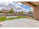 View of backyard featuring low maintenance landscaping, artificial turf, and a stone paver patio at 30303 W Whitton Ave, Buckeye, AZ 85396