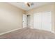 This bedroom features neutral paint, plush carpeting, and a spacious closet at 30303 W Whitton Ave, Buckeye, AZ 85396