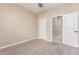 Bedroom boasts neutral paint and plush carpeting, adjacent to ensuite at 30303 W Whitton Ave, Buckeye, AZ 85396