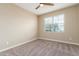Cozy bedroom features neutral paint, plush carpeting, and a bright window at 30303 W Whitton Ave, Buckeye, AZ 85396
