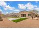 Rear exterior showcasing desert landscaping, artificial grass and low maintenance features at 30303 W Whitton Ave, Buckeye, AZ 85396