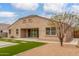 Rear exterior view of the home featuring well-manicured landscaping and a spacious backyard at 30303 W Whitton Ave, Buckeye, AZ 85396