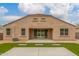 The back of the home features a patio, artificial grass and low maintenance landscaping at 30303 W Whitton Ave, Buckeye, AZ 85396