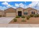 Charming single-story home featuring desert landscaping, a neutral color palette, and a two-car garage at 30303 W Whitton Ave, Buckeye, AZ 85396