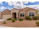 Charming single-story home featuring desert landscaping, a neutral color palette, and a two-car garage at 30303 W Whitton Ave, Buckeye, AZ 85396