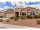 Charming single-story home featuring desert landscaping, a neutral color palette, and a two-car garage at 30303 W Whitton Ave, Buckeye, AZ 85396