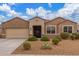 Charming single-story home featuring desert landscaping, a neutral color palette, and a two-car garage at 30303 W Whitton Ave, Buckeye, AZ 85396