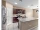 Spacious kitchen featuring dark cabinetry, stainless steel appliances, granite countertops, and a large island at 30303 W Whitton Ave, Buckeye, AZ 85396