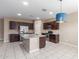 Spacious kitchen with stainless steel appliances, granite countertops, and a large island with a sink at 30303 W Whitton Ave, Buckeye, AZ 85396